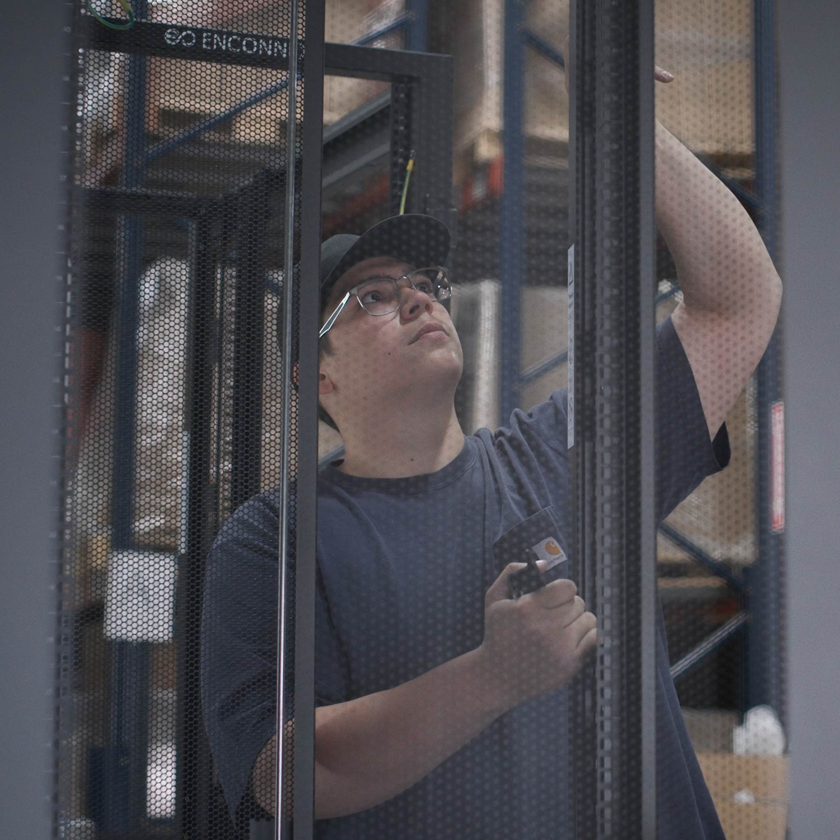 Enconnex warehouse and assembly worker assembling data center server cabinet